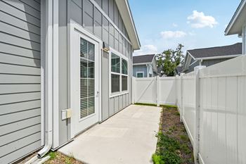 A grey house with a white fence and a white door.  at The Sophia, Venice, FL, 34275